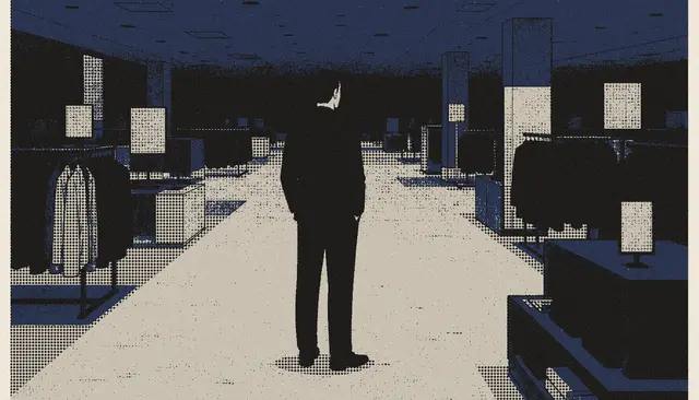 A lone figure standing in an empty store at night